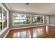 Bright living room with hardwood floors, large windows offering scenic lake views, and ample natural light at 2913 Carmia Dr, Orlando, FL 32806