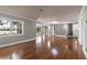 Open living room with gleaming hardwood floors, neutral walls, and access to multiple rooms and lake views at 2913 Carmia Dr, Orlando, FL 32806