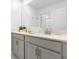 Bathroom featuring a double vanity with modern fixtures, a large mirror, and white walls at 2945 Simile St, Kissimmee, FL 34746