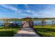 Community dock on a serene lake with a gazebo and kayaks for resident enjoyment at 2945 Simile St, Kissimmee, FL 34746