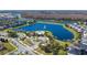 Aerial view of a community pool, lake, and surrounding homes, showcasing the neighborhood's amenities at 3270 Mt Vernon Way, Kissimmee, FL 34741