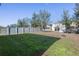 Large, fully-fenced backyard with lush green grass and mature trees at 3270 Mt Vernon Way, Kissimmee, FL 34741
