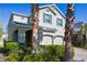 Two-story home showcasing lush landscaping, a two-car garage, and a well-maintained facade at 3270 Mt Vernon Way, Kissimmee, FL 34741