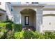 Inviting front porch with decorative shrubbery and a modern front door at 3270 Mt Vernon Way, Kissimmee, FL 34741