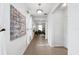 Inviting hallway with neutral tiling, light fixture, and modern art piece at 3270 Mt Vernon Way, Kissimmee, FL 34741