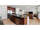 Open kitchen with stainless steel appliances and an island that overlooks the living area at 3270 Mt Vernon Way, Kissimmee, FL 34741