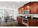 Modern kitchen featuring stainless steel appliances, dark cabinets, and granite countertops at 3270 Mt Vernon Way, Kissimmee, FL 34741