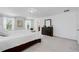 Bright bedroom boasts neutral carpeting, three sunny windows, and a view into the ensuite bathroom at 3270 Mt Vernon Way, Kissimmee, FL 34741
