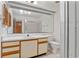 Bright bathroom features a large mirror, vanity, toilet, and glass-enclosed shower at 3275 Windy Wood Dr, Orlando, FL 32812