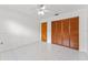 Bedroom with white walls, tile flooring, ceiling fan, and closet with paneled doors at 3275 Windy Wood Dr, Orlando, FL 32812