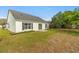 Exterior of home showing backyard with mature trees and plenty of sunlight at 3304 Kelsey Ln, St Cloud, FL 34772