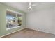 Bedroom with a large window offering a view of the outdoors and a ceiling fan at 3304 Kelsey Ln, St Cloud, FL 34772