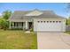 Charming single-story home with a well-maintained lawn and attached two-car garage in a quiet neighborhood at 3304 Kelsey Ln, St Cloud, FL 34772