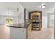 Well-lit kitchen with stainless steel appliances and a breakfast bar overlooking the living area at 3304 Kelsey Ln, St Cloud, FL 34772