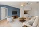 Stylish living room with vaulted ceilings, a blue accent wall, and an open concept design at 3304 Kelsey Ln, St Cloud, FL 34772