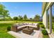 Outdoor patio featuring wicker sectional sofa and coffee table, overlooking landscaped yard at 3304 Kelsey Ln, St Cloud, FL 34772