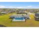 Aerial view of a fenced swimming pool and backyard of a one story house surrounded by a well-maintained green lawn and several trees at 3304 Kelsey Ln, St Cloud, FL 34772
