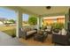 Inviting covered porch with cozy seating and a neutral color palette, perfect for enjoying the outdoors at 3304 Kelsey Ln, St Cloud, FL 34772