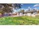 Expansive backyard features a well-maintained lawn, patio area, and mature trees at 3520 Arch St, Orlando, FL 32808