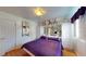 Comfortable bedroom featuring a large bed with purple bedding and custom mirrored headboard at 3520 Arch St, Orlando, FL 32808