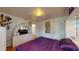 Cozy bedroom with a purple bed, light-colored walls, and unique decorative touches at 3520 Arch St, Orlando, FL 32808