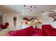 Bright living room features modern decor, unique lighting, and comfortable red seating at 3520 Arch St, Orlando, FL 32808