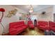 Fun living room featuring red sofas, stylish gold rug, and modern art at 3520 Arch St, Orlando, FL 32808