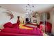 Open living room featuring eclectic decor, modern lighting, and comfortable red sofas at 3520 Arch St, Orlando, FL 32808