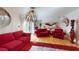Bright living room features hardwood floors, unique lighting, and comfortable red seating at 3520 Arch St, Orlando, FL 32808