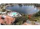 Aerial view of the backyard of a home that backs up to a lake and community pool at 390 Miro Dr, Davenport, FL 33837