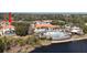 Aerial view of the community pool and clubhouse next to a lake at 390 Miro Dr, Davenport, FL 33837