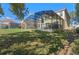 Spacious backyard with screened-in pool and lush lawn at 390 Miro Dr, Davenport, FL 33837