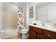 Bathroom with a combined bathtub and shower featuring a Mickey Mouse shower curtain and essential amenities at 390 Miro Dr, Davenport, FL 33837