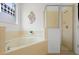 Bright bathroom featuring large soaking tub with tile surround and glass shower at 390 Miro Dr, Davenport, FL 33837