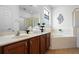 Bathroom featuring double sink with granite countertop, garden tub, and glass enclosed shower at 390 Miro Dr, Davenport, FL 33837