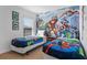 Vibrant ' bedroom with superhero-themed decor, twin beds, and comfortable bedding at 390 Miro Dr, Davenport, FL 33837