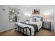 Cozy bedroom features a comfortable queen-sized bed, bedside tables with lamps, and a window view at 390 Miro Dr, Davenport, FL 33837