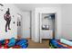 Bright, colorful bedroom with two twin beds, television, and a closet for storage at 390 Miro Dr, Davenport, FL 33837