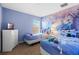 A bright bedroom with a frozen theme and two twin beds, creating a fun and playful atmosphere at 390 Miro Dr, Davenport, FL 33837