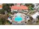 Aerial view of the community pool with lounge chairs, umbrellas, and a playground at 390 Miro Dr, Davenport, FL 33837