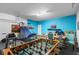 Spacious game room with foosball table and basketball hoop at 390 Miro Dr, Davenport, FL 33837