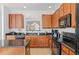 Modern kitchen showcases granite countertops, stainless steel appliances, and wooden cabinetry at 390 Miro Dr, Davenport, FL 33837