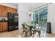 Kitchenette with a glass table, stainless steel appliances, and views of the screened-in lanai at 390 Miro Dr, Davenport, FL 33837