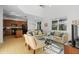 Living room with tile flooring, a sofa, an adjacent kitchen, and high ceilings at 390 Miro Dr, Davenport, FL 33837