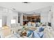 Bright living room with sofas, tile floors, and adjacent kitchen and dining area at 390 Miro Dr, Davenport, FL 33837