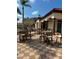 Beautiful patio with tables and chairs, perfect for outdoor entertaining with a building alongside at 390 Miro Dr, Davenport, FL 33837
