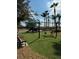 Community playground featuring modern play equipment, swings, and soft, safe turf at 390 Miro Dr, Davenport, FL 33837