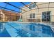Backyard with large screened pool and outdoor dining at 390 Miro Dr, Davenport, FL 33837