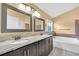 Bathroom features double vanity, marble countertops and a large soaking tub at 477 Bohannon Blvd, Orlando, FL 32824