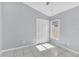 Bedroom featuring tile floors, closet with louvered doors, and a window at 477 Bohannon Blvd, Orlando, FL 32824
